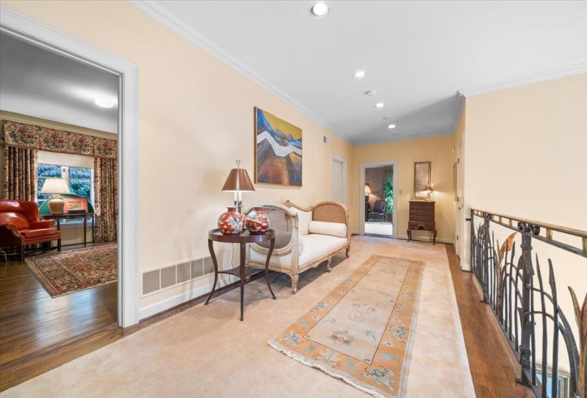 Hallway featuring ornamental molding, recessed lighting, wood finished floors, and carpet flooring