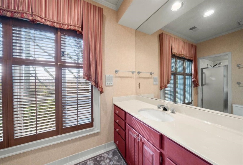 Bathroom featuring crown molding, vanity, a shower stall, and recessed lighting