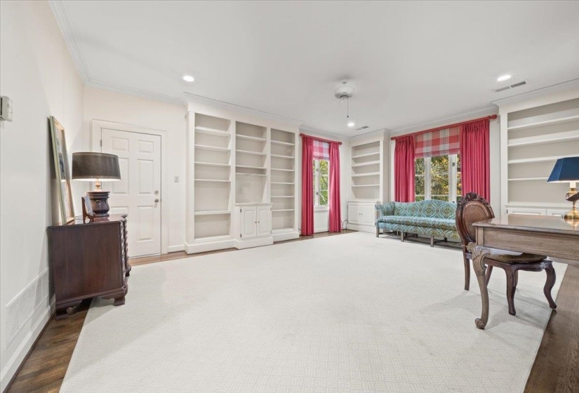 Office space featuring built in shelves, crown molding, wood finished floors, and recessed lighting