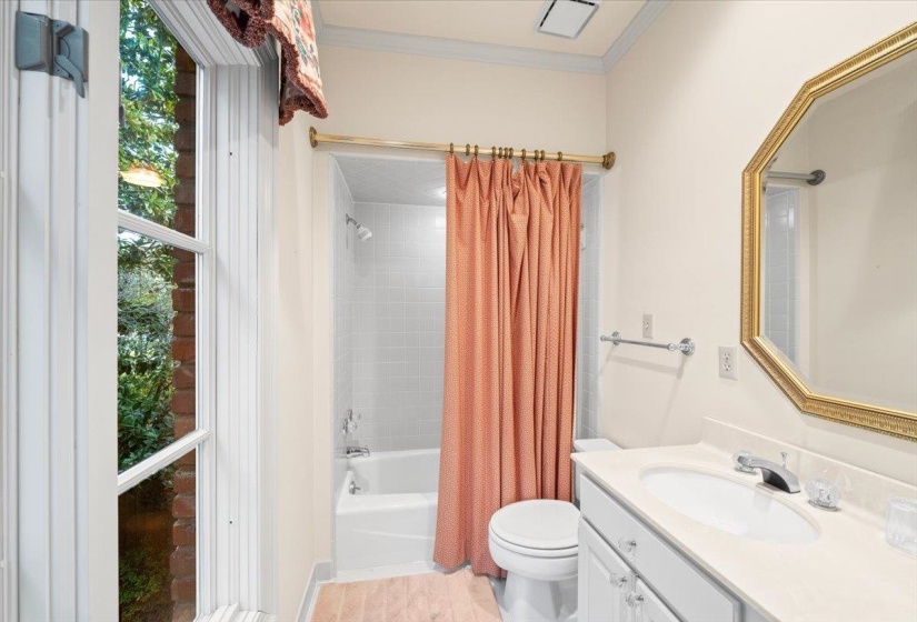 Full bathroom with shower / bath combo, vanity, and crown molding