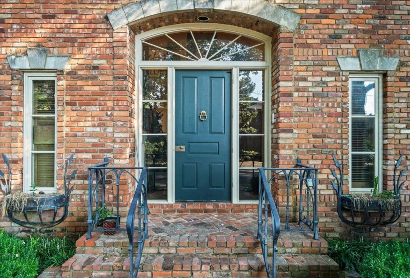 Property entrance featuring brick siding