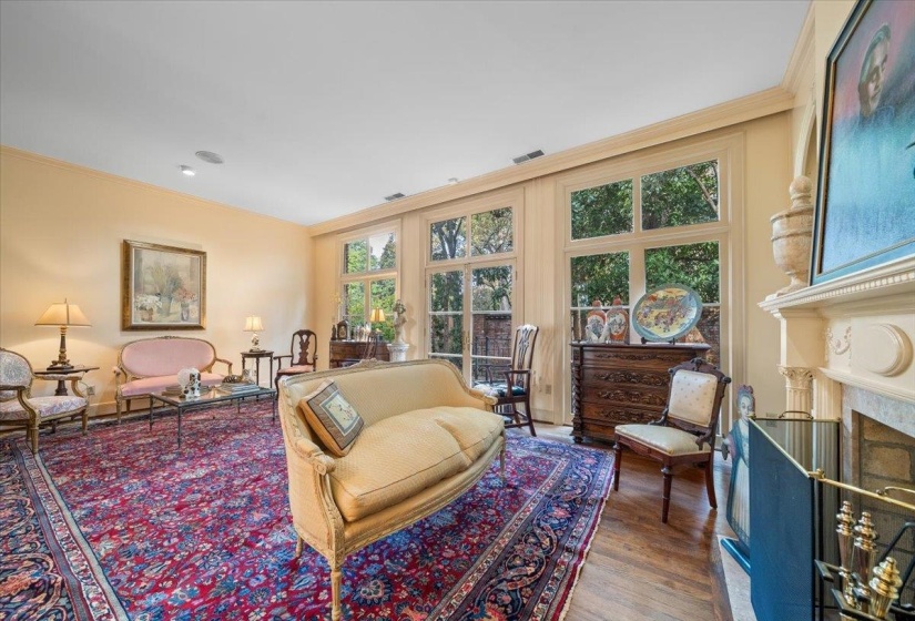 Living room featuring ornamental molding, dark wood finished floors, and a fireplace