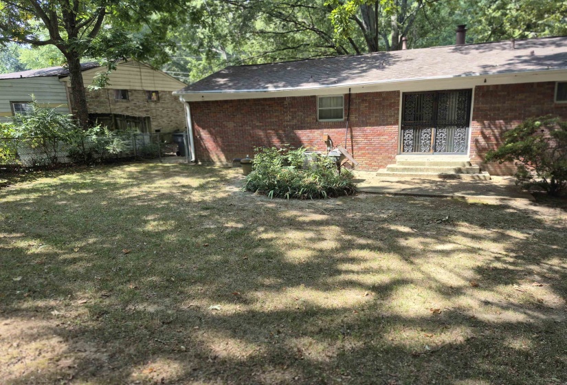 View of side of property with brick siding and entry steps