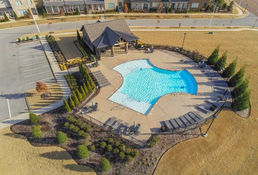 Community pool with a patio and a residential view