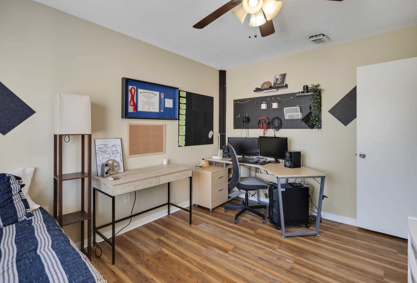 Office area featuring a textured ceiling, a ceiling fan, and light wood-type flooring