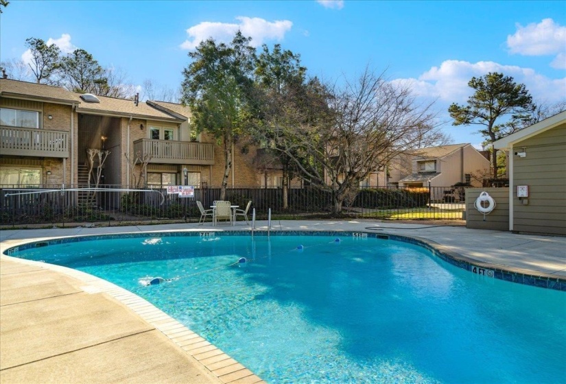 Community pool with a patio, a balcony, and a residential view