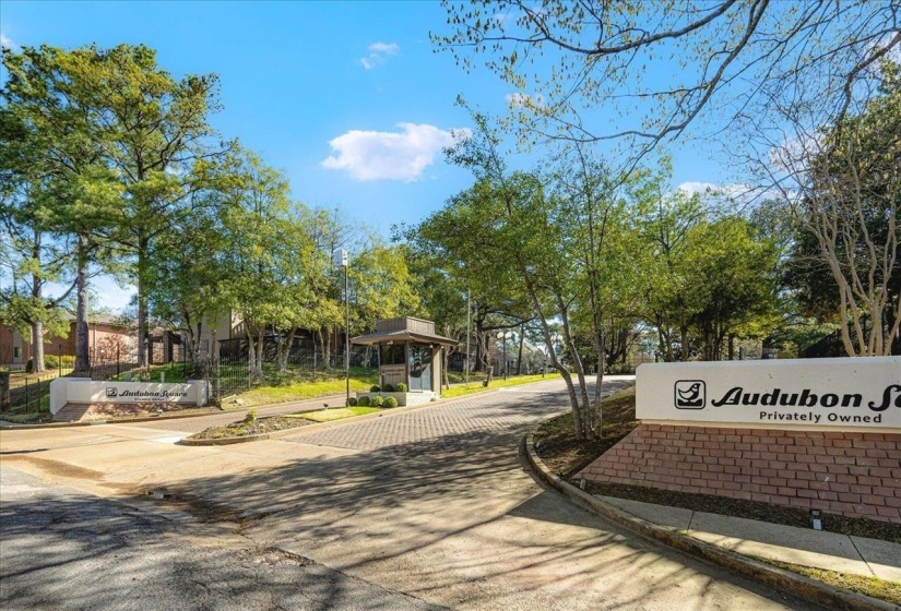 View of asphalt road featuring curbs and sidewalks