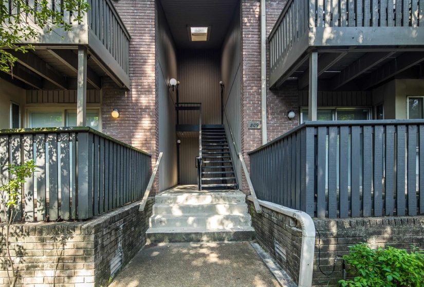 Property entrance featuring brick siding