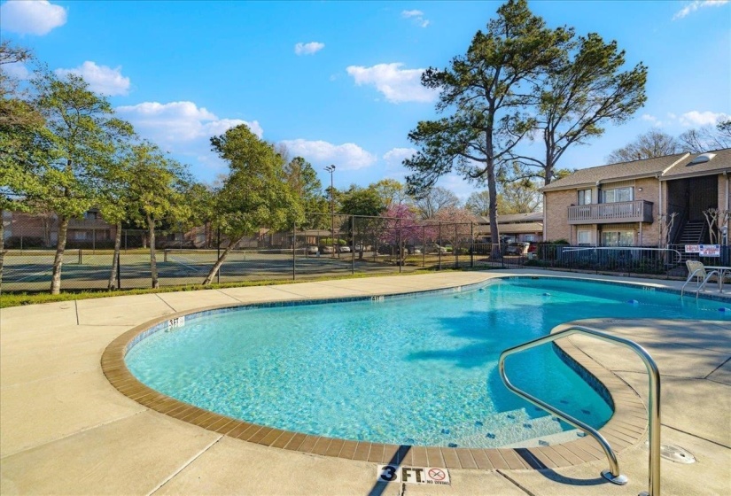 Community pool featuring a patio