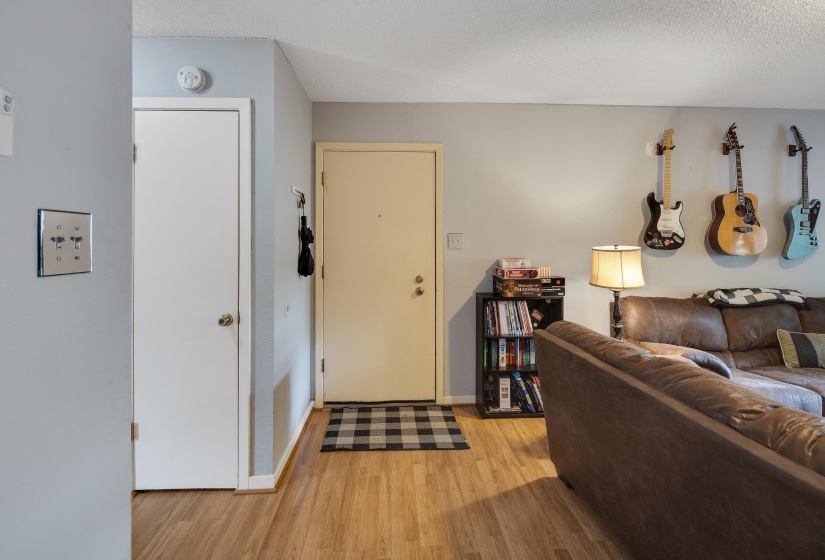 Living room featuring light wood-type flooring and a textured ceiling