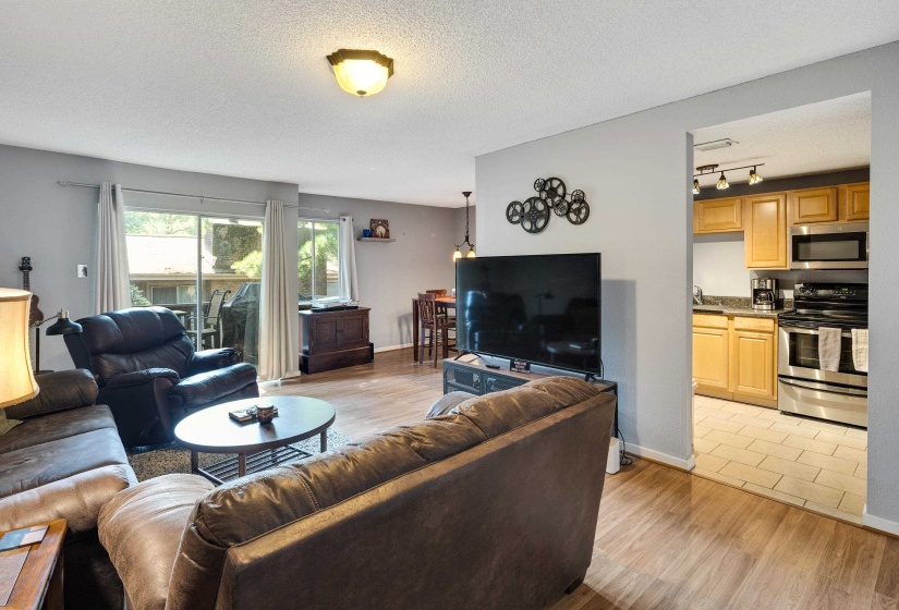 Living room with light wood-type flooring and a textured ceiling