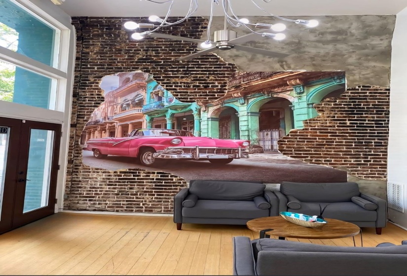 Lobby featuring brick wall and a high ceiling