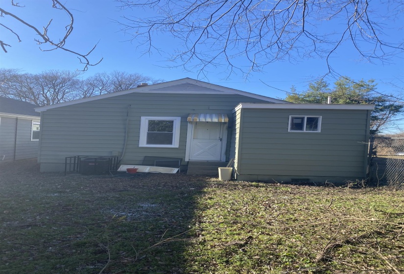 Back of property with a yard