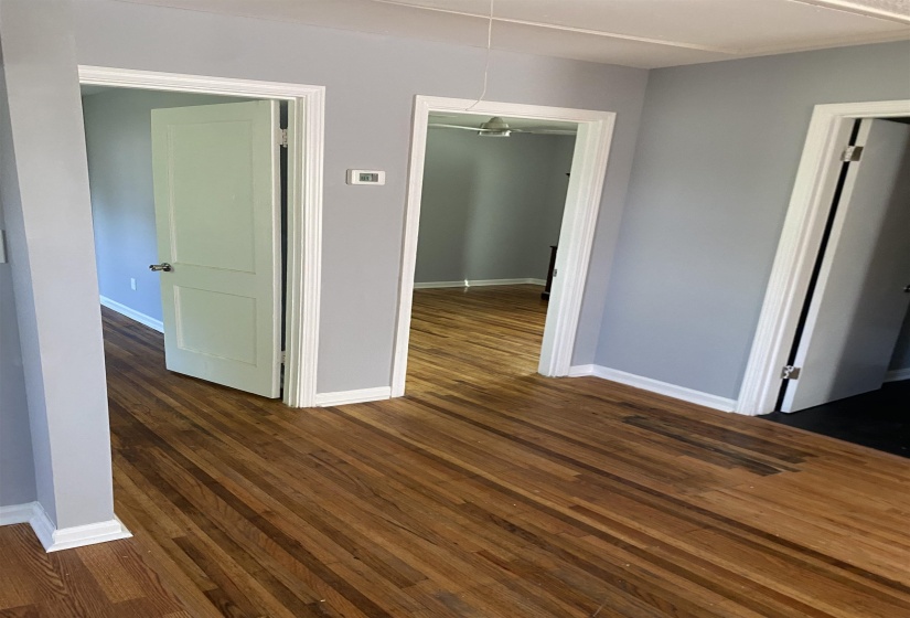 Spare room with attic access and dark wood-style flooring