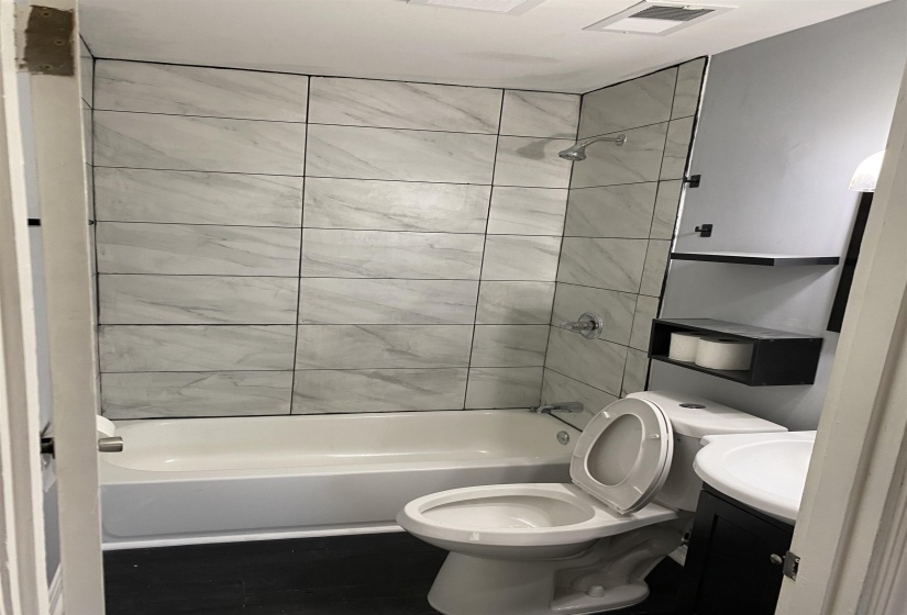 Bathroom with vanity and  shower combination