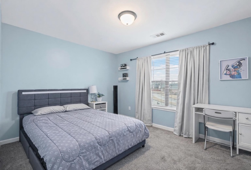 Bedroom with light carpet and baseboards