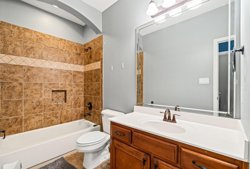 Full bath featuring tub / shower combination, vanity, and tile patterned flooring