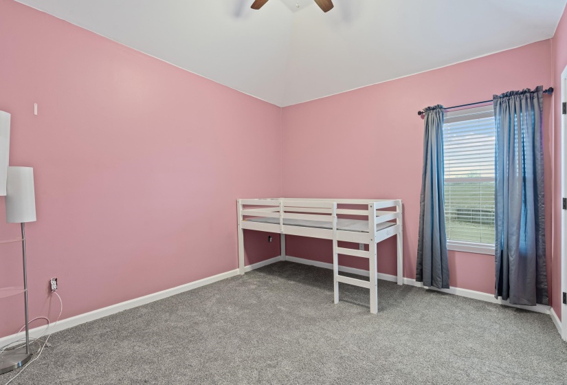 Bedroom featuring light colored carpet and a ceiling fan