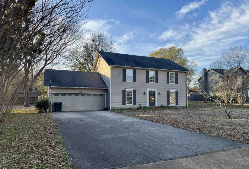 Colonial home with driveway and an attached garage