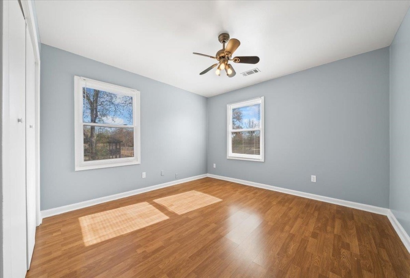 Empty room featuring wood finished floors and a ceiling fan