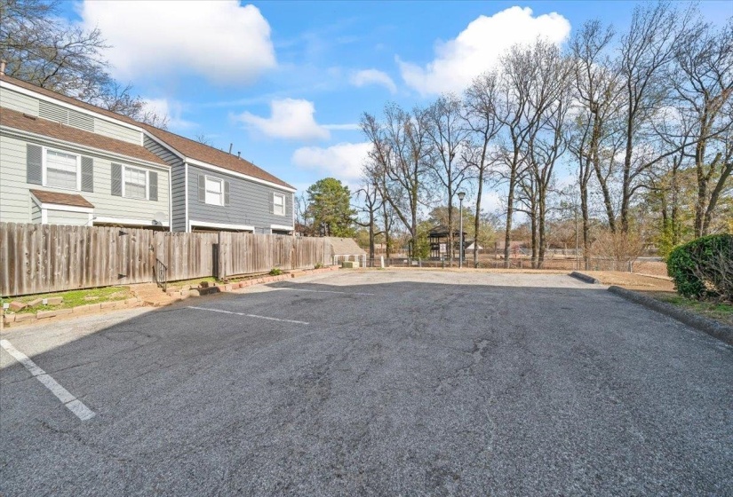 Uncovered parking lot featuring a residential view