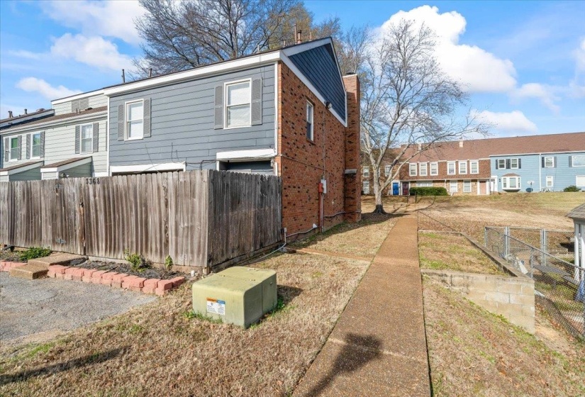 View of side of home featuring a residential view and brick siding
