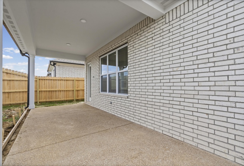 Covered patio featuring an exposed aggregate concrete surface