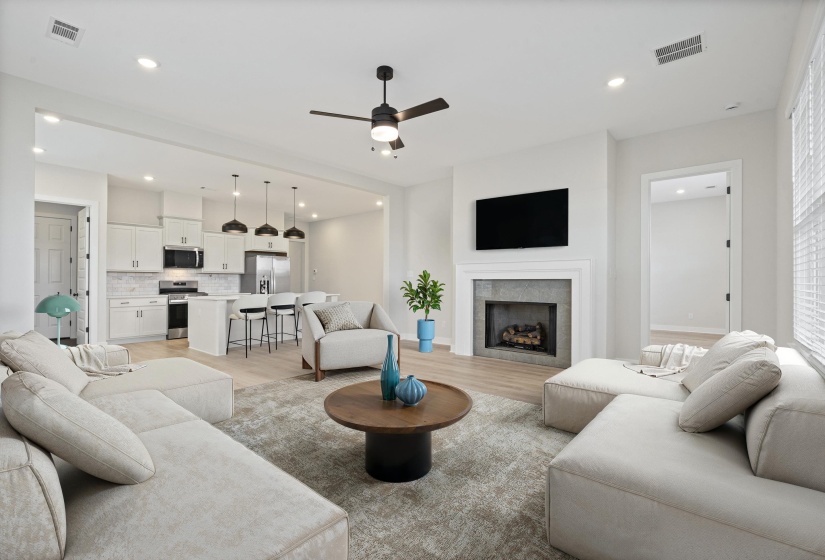 Open concept living area featuring wood-finish flooring and recessed lighting