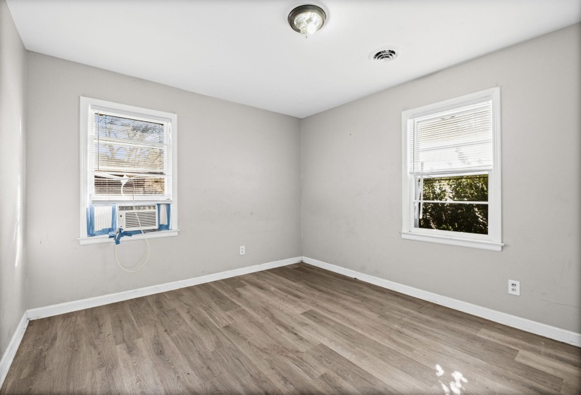 Unfurnished room with light wood-style floors and healthy amount of natural light