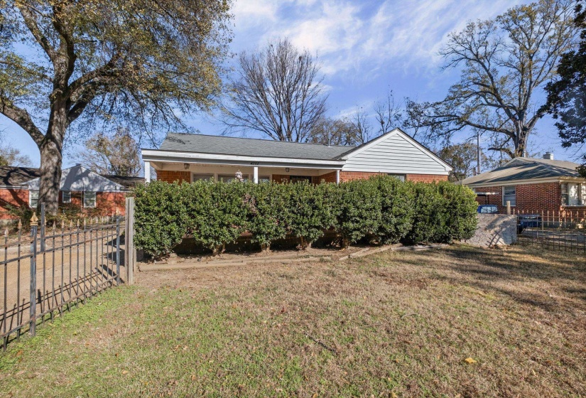 Back of property featuring brick siding