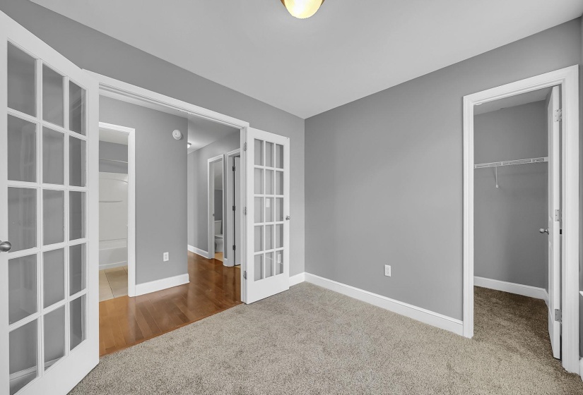 Interior room featuring gray wall paint and light-colored carpeting