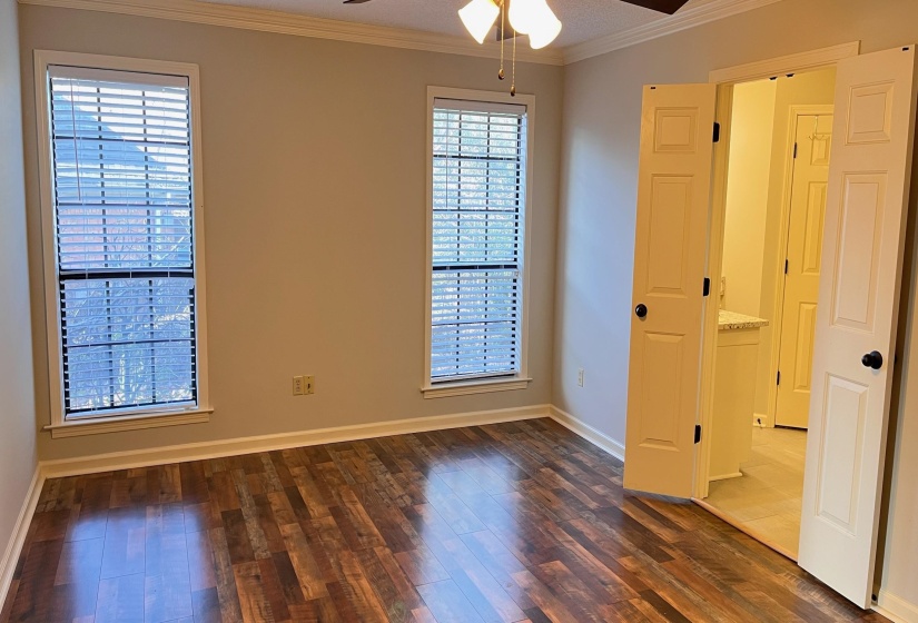 Master Bedroom featuring crown molding, dark wood-style floors, and ceiling fan