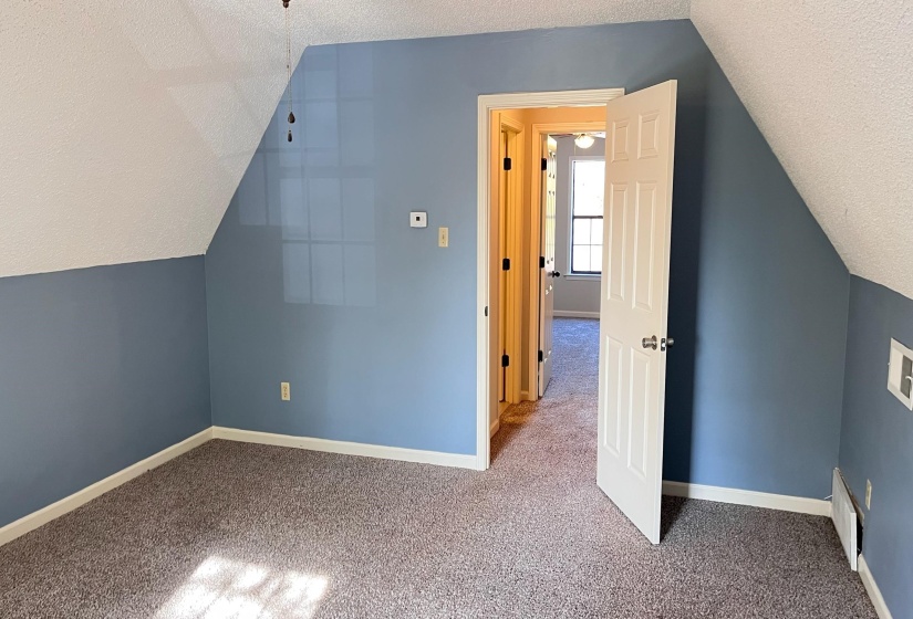 4th Bedroom room with a textured ceiling, lofted ceiling, and carpet floors