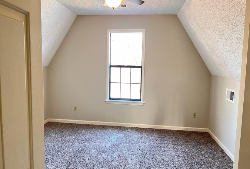 5th bedroom with a textured ceiling, carpet flooring, and a ceiling fan