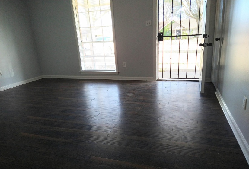 Unfurnished room featuring dark wood-style floors