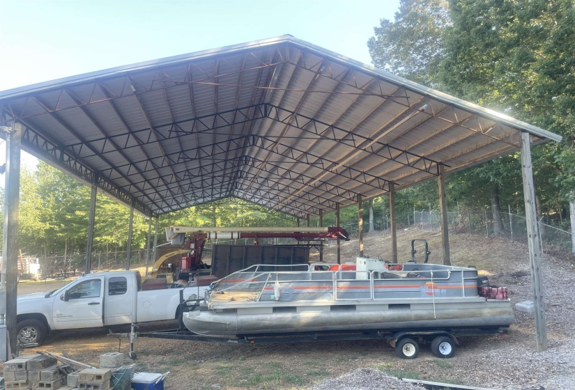 View of parking / parking lot featuring a detached carport
