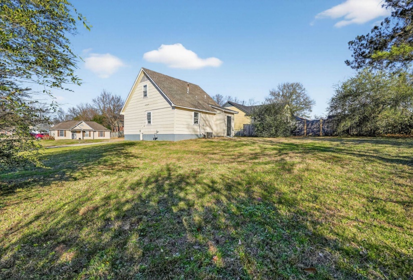 View of side of property with a yard