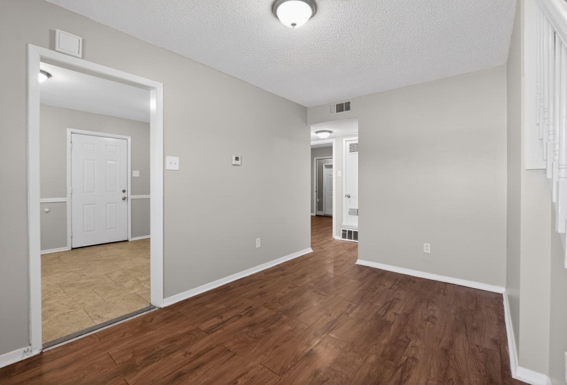 Unfurnished room with dark wood finished floors and a textured ceiling