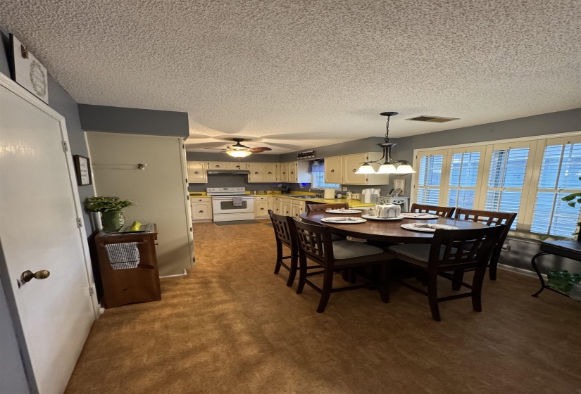 Dining room featuring a textured ceiling and a ceiling fan