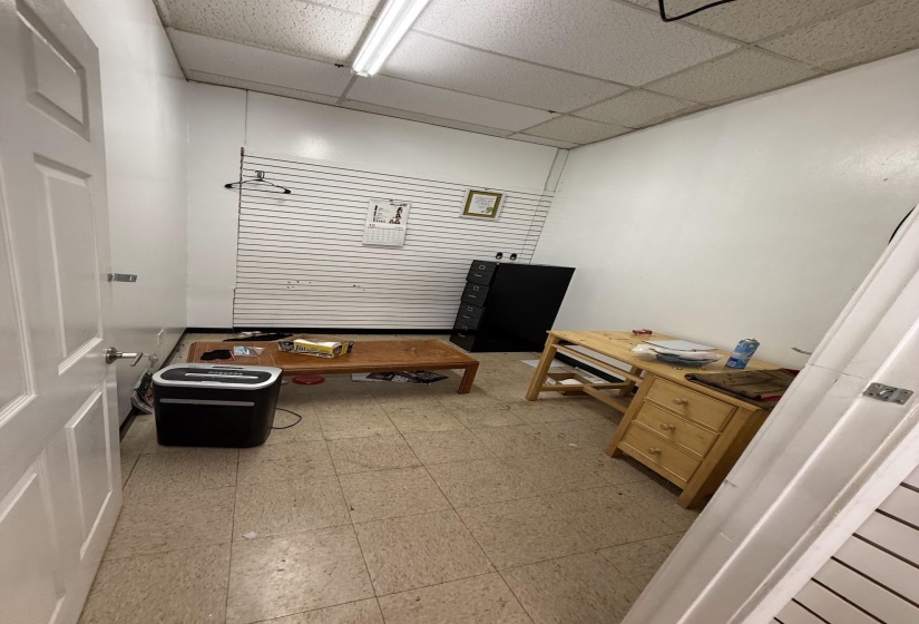 Miscellaneous room with a paneled ceiling and light floors