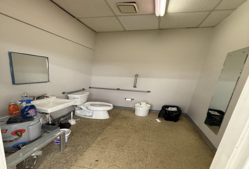 Bathroom with a drop ceiling and toilet