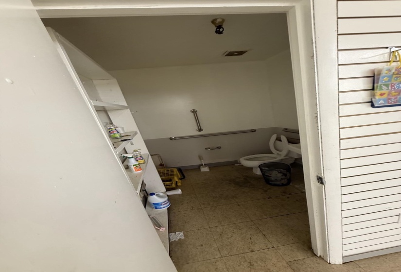 Bathroom with toilet and light tile patterned floors