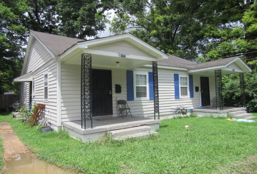 Bungalow with covered porch, a front yard, and roof with shingles