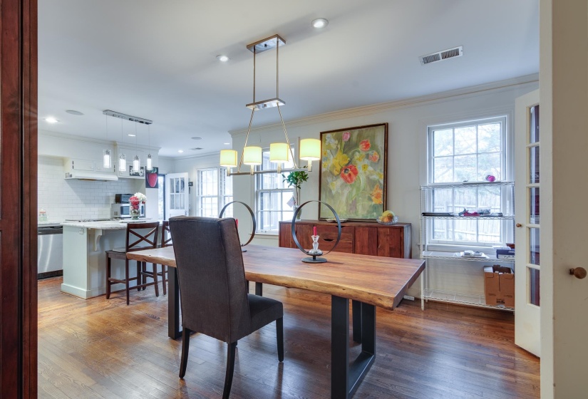 Dining room featuring crown molding, light wood-style flooring, and recessed lighting