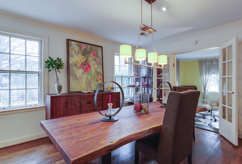 Dining space featuring ornamental molding, wood-type flooring, and a chandelier