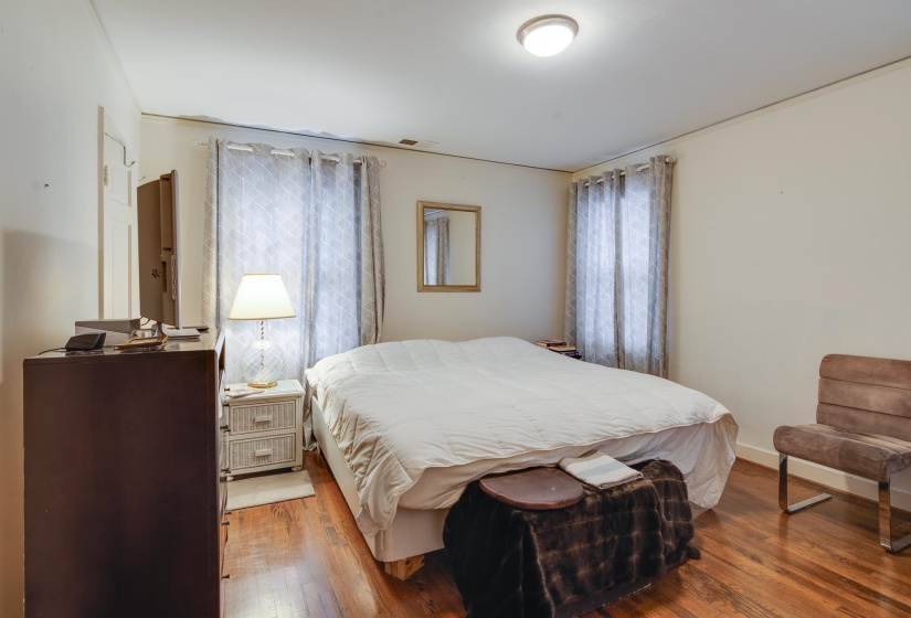 Bedroom with hardwood / wood-style flooring