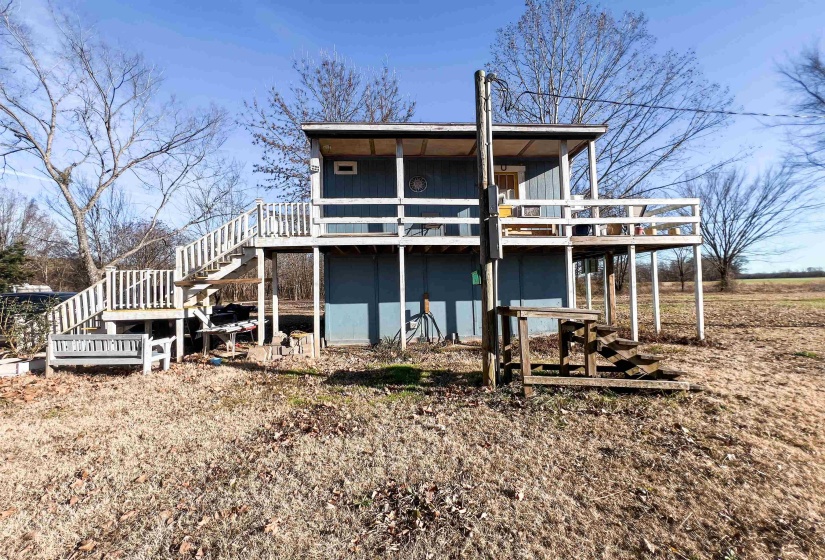 Back of property featuring a deck and stairs
