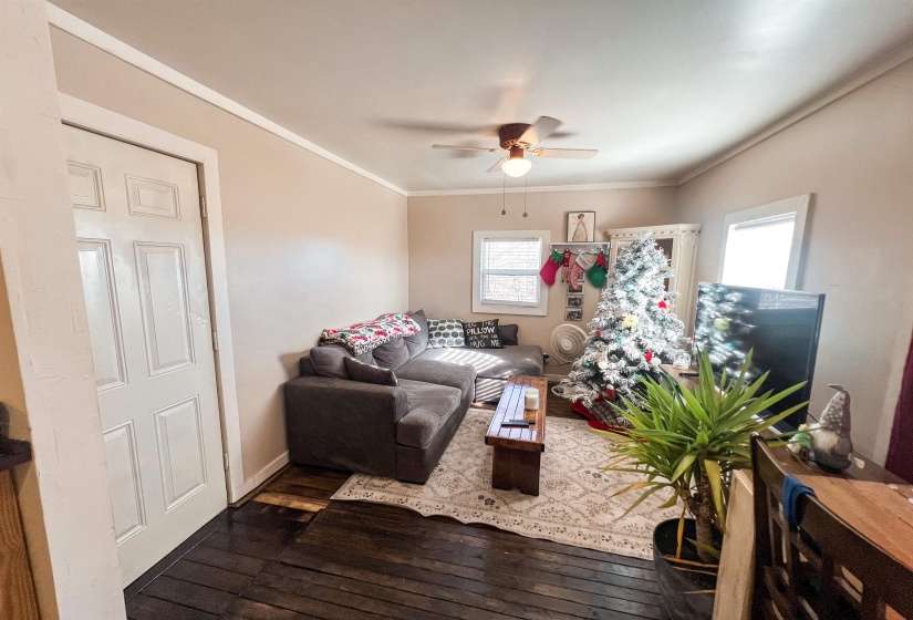 Living room area featuring dark wood flooring.