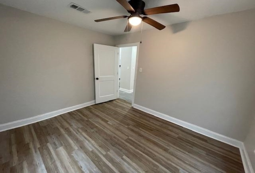 Unfurnished room featuring wood finished floors and a ceiling fan
