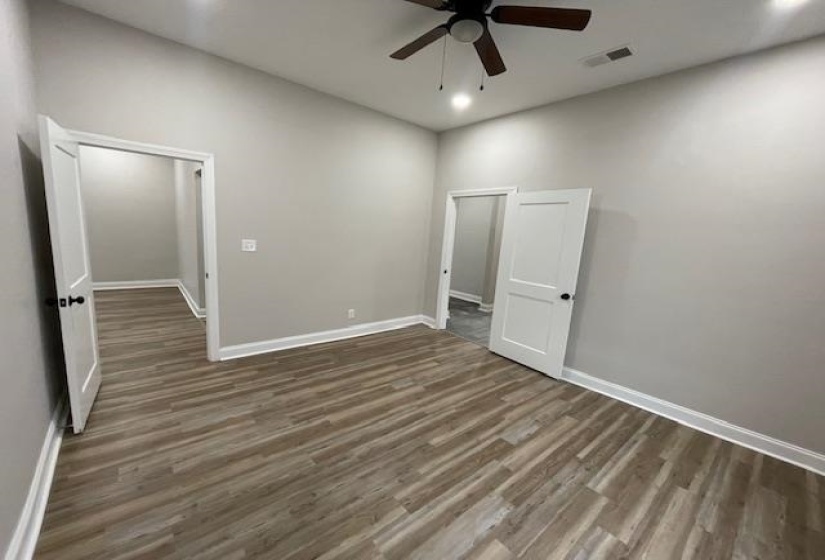 Unfurnished bedroom with wood finished floors, a ceiling fan, and recessed lighting